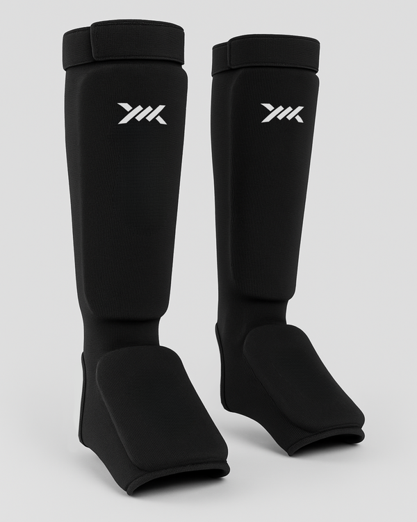Espinilleras Caged Core – Negro/Blanco