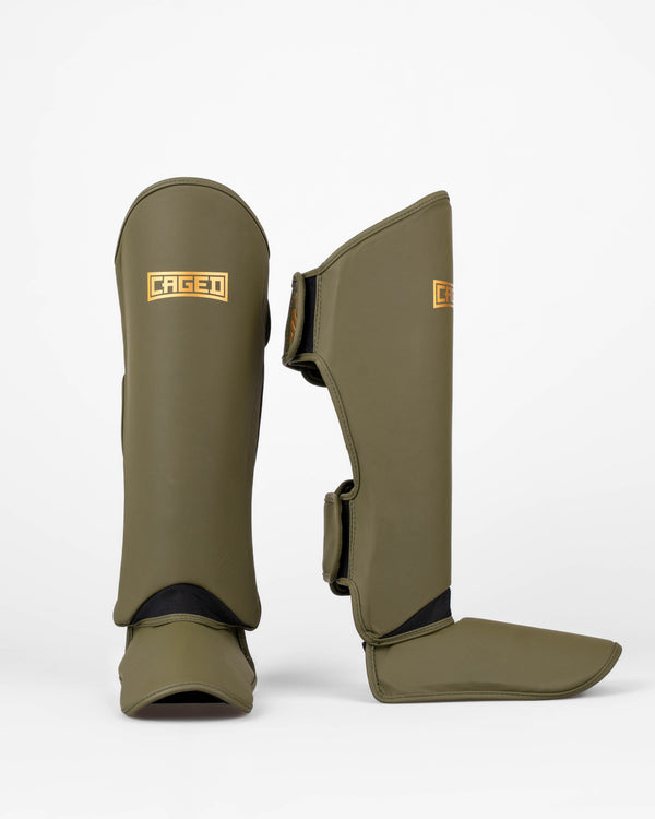 Ochraniacze na piszczele Caged Shadow – Khaki/Złoto