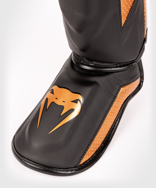 Caneleiras Venum Elite Evo – Preto/Bronze