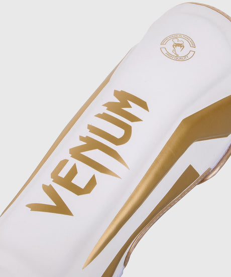 Caneleiras de kickboxing Venum Elite – Branco/Ouro