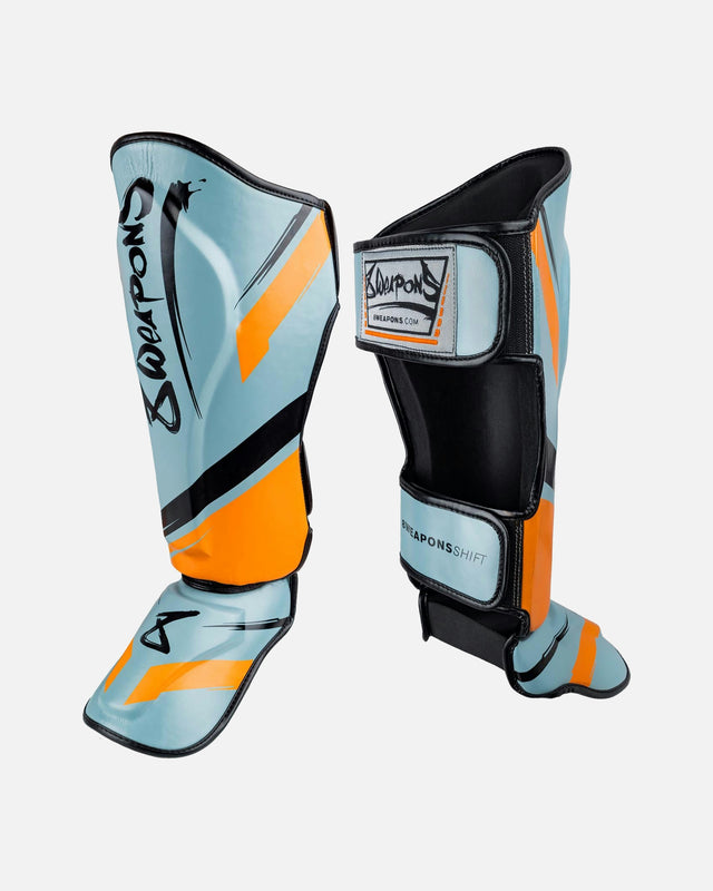 8 WEAPONS Skinnebensbeskyttere Shift – Isgrå/Orange